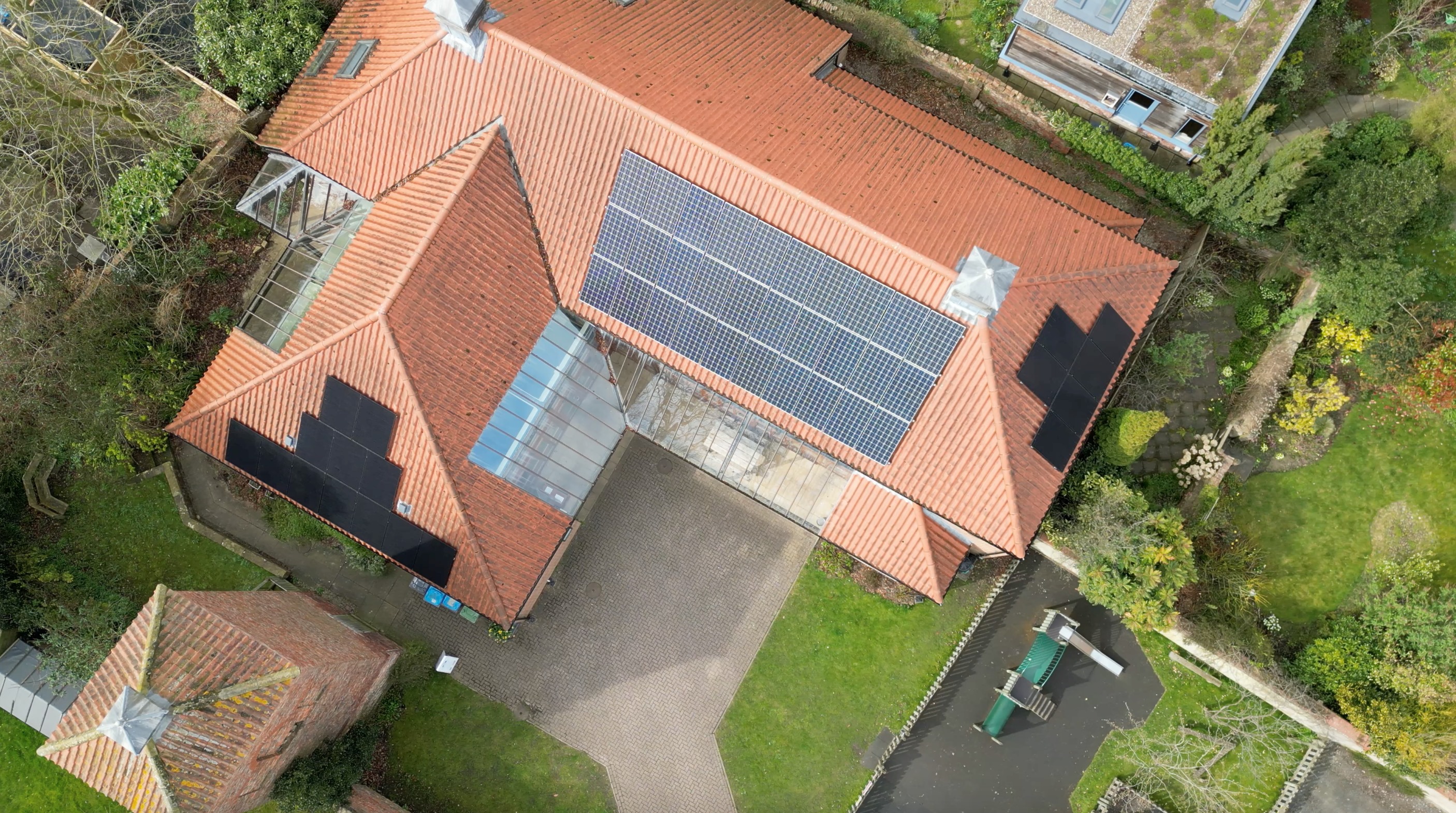 Arial view of a building with solar panels on roof 