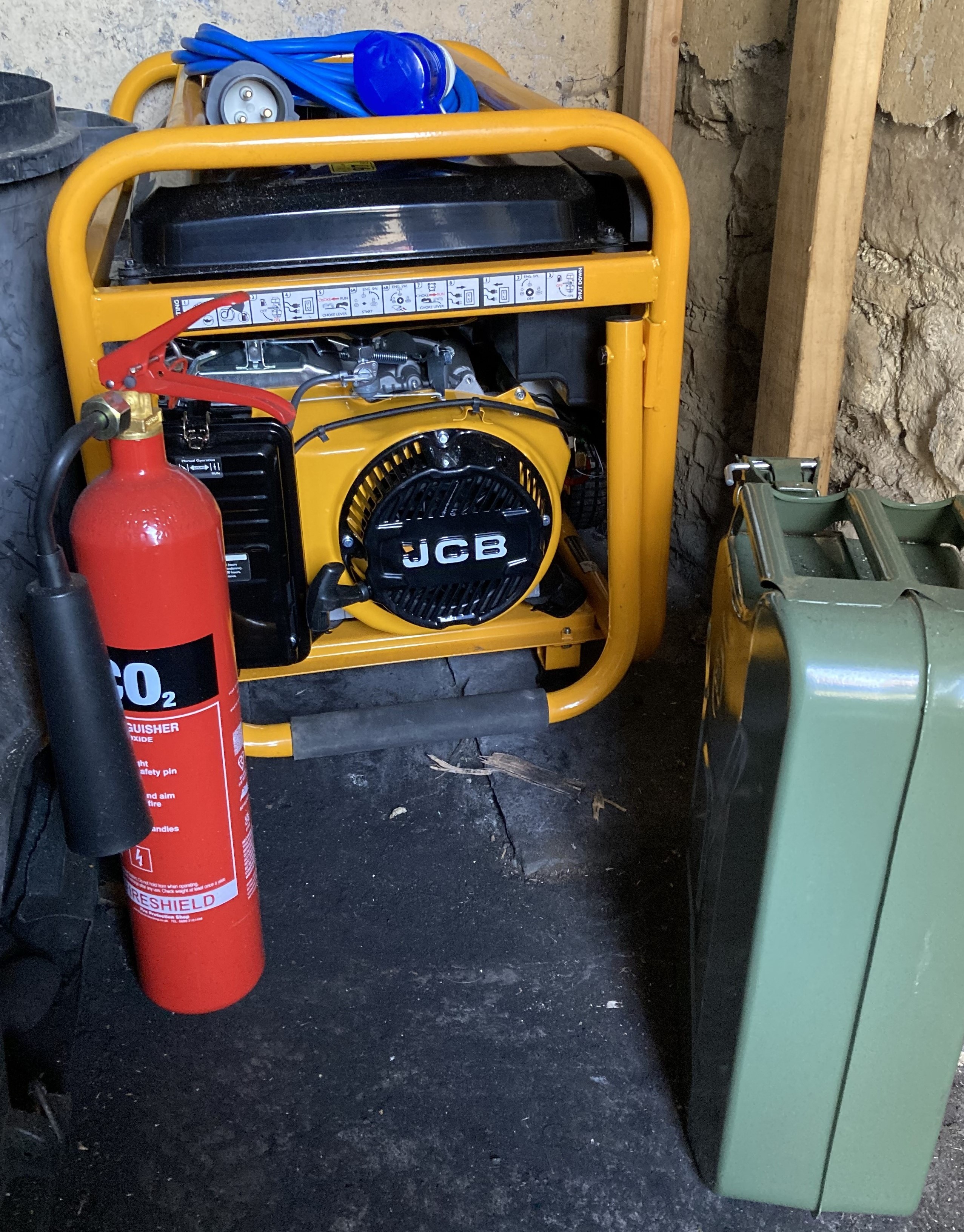Pictured: A yellow portable generator with a red fire extinguisher